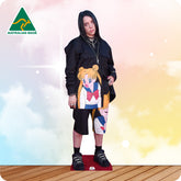 Cardboard cutout of a person wearing a colorful outfit with anime design on a gradient background.